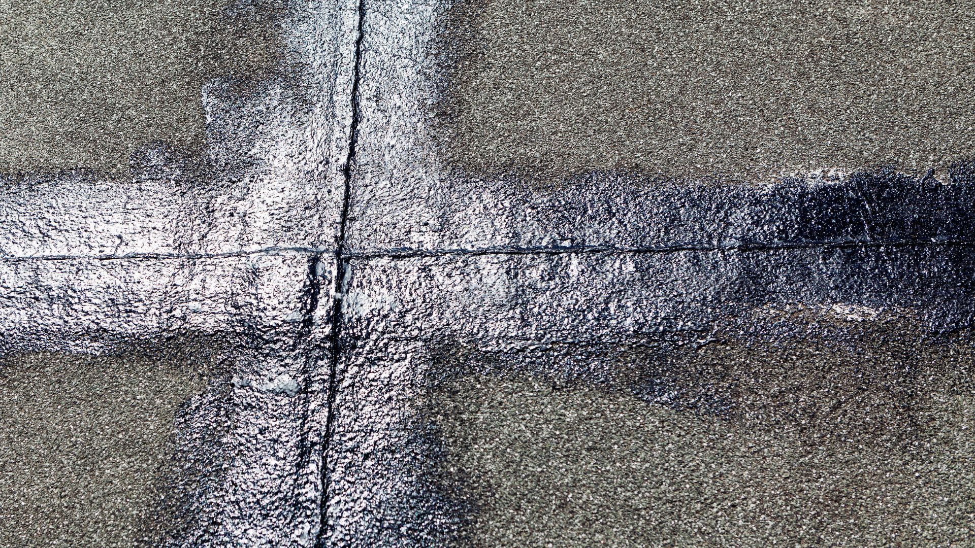 A black and white photo of a cross on the ground