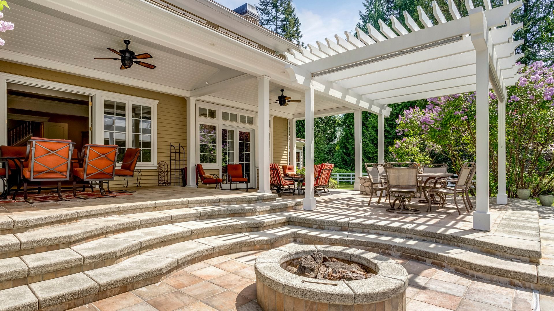 A patio with a fire pit and seating area