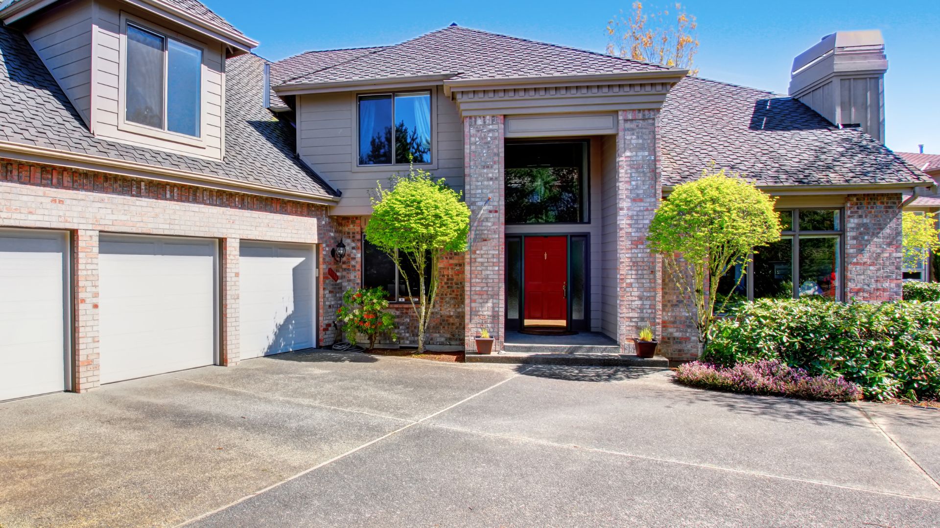 A large brick house with a red door